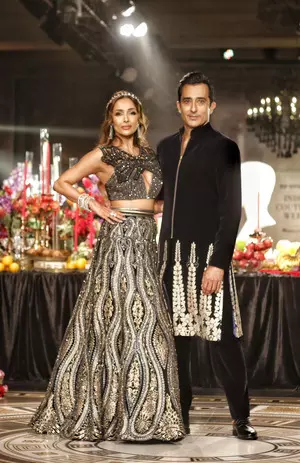 FDCI Couture Week: Malaika dazzles in Siddartha Tytler’s black & golden lehenga