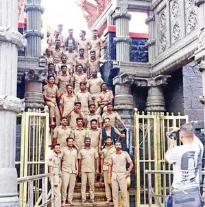 Photo of cops violating Sabarimala temple traditions goes viral; report sought